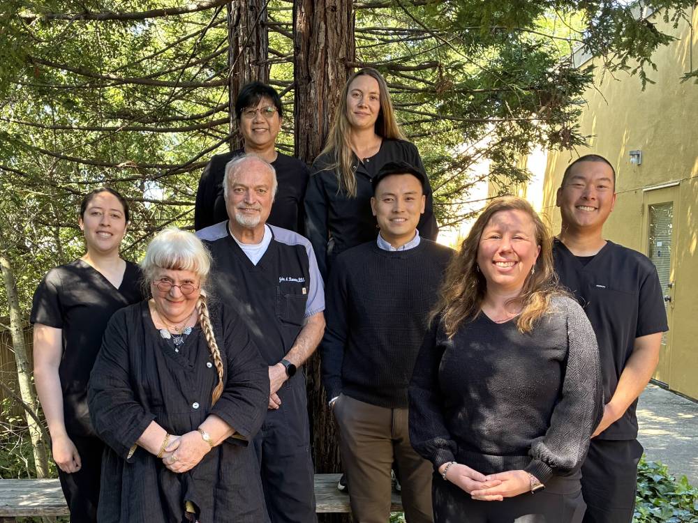 Mt. Hermon Dental Care Team, Family and Cosmetic Dentist in Scotts Valley, CA The Mt. Hermon Dental Care dental team posing together outdoors among the redwoods in Scotts Valley, CA
