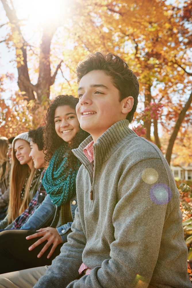 Family and Pediatric Dental Care in Scotts Valley, CA Group of smiling teenagers enjoying a sunny autumn day outdoors, representing young patients who receive family dental care in the Scotts Valley community
