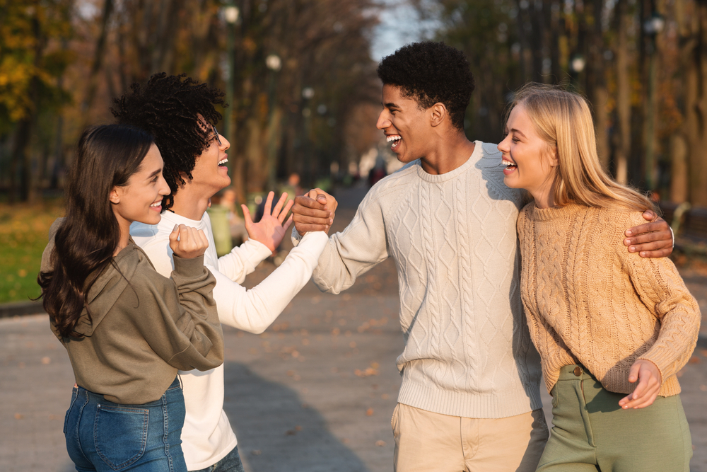 Group of friends laughing and smiling together outdoors, representing the confidence that comes from quality dental care in Scotts Valley and the surrounding Santa Cruz Mountains communities 