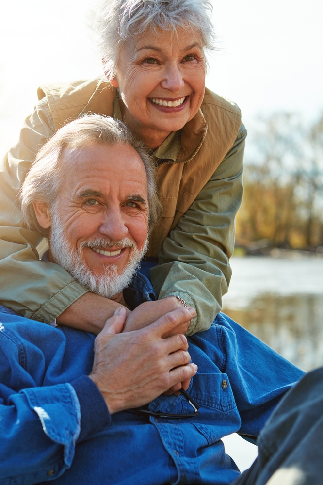 Restorative Dentistry for Adults in Scotts Valley, CA Happy senior couple smiling outdoors, representing older adult patients who receive restorative and family dental care at Mt. Hermon Dental Care in Scotts Valley