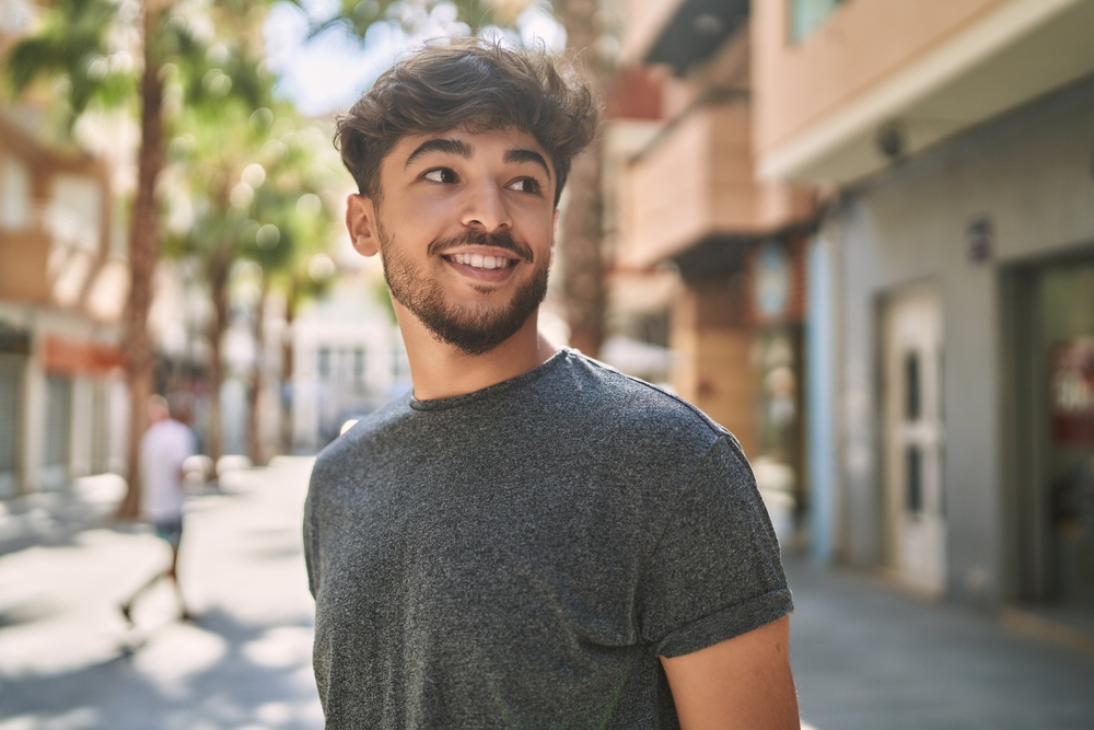 Young man with a bright, healthy smile enjoying a sunny day outdoors in Scotts Valley, CA 